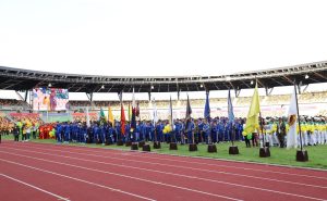 a group of people in blue uniforms standing on a track