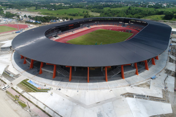 a large stadium with a black roof