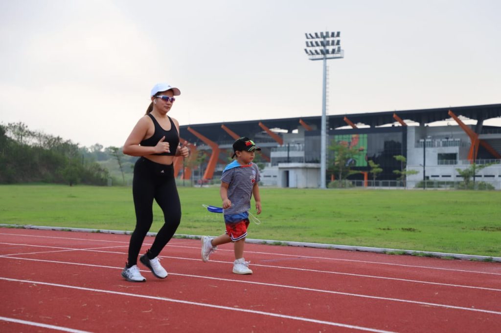 a person and a child running on a track