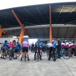a group of people on bicycles in a stadium