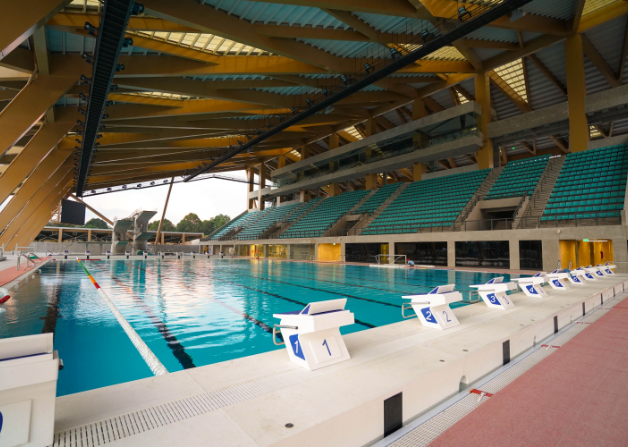 a swimming pool with green seats