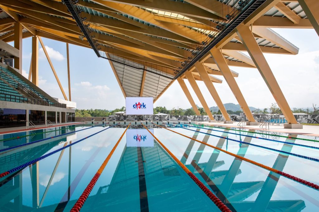 a swimming pool with a large white sign