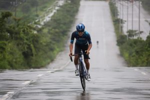 a person riding a bicycle on a wet road